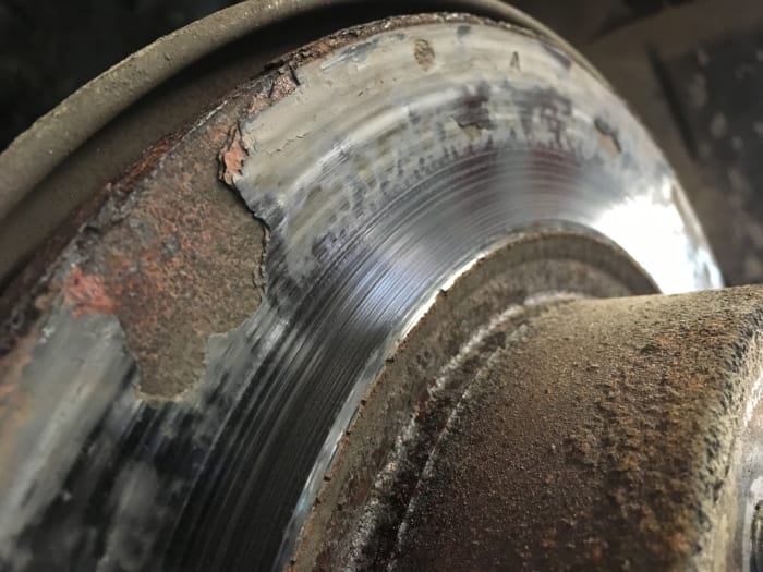 The brake rotor in this picture is rusted to the point that the metal is starting to flake off. Every time the customer would apply the brakes it would make a thumping noise.