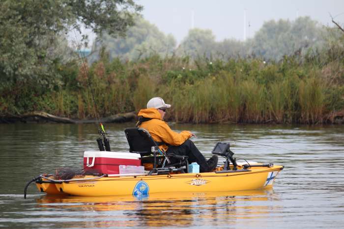 Fisherman in sit-on-top Hobie kayak.