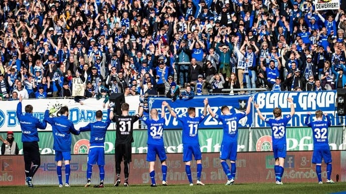 SV Darmstadt 98 players celebrate with fans inside Stadion Böllenfalltor in Darmstadt, Germany, in 2016. The 2015-16 season marked the club's first foray in the Bundesliga in 33 years.