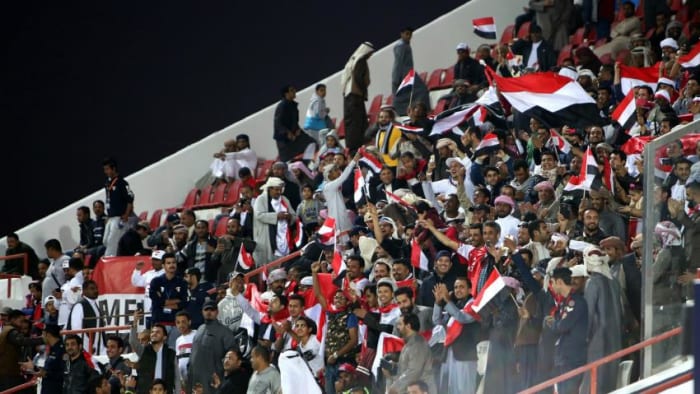 In Doha, Qatar, fans inside Suheim bin Hamad Stadium celebrate during a 2019 Asian Cup qualifier between Yemen and Nepal on Mar. 27, 2018. Yemen won the match 2-1 to secure its first Asian Cup as a unified nation.