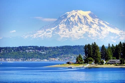 View of Mount Rainier from Fox Island Bridge and the waters of the Puget Sound. Home to many Great Blue Herons.