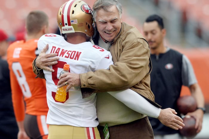 Former Cleveland Browns lineman and current radio announcer, Doug Dieken (right), embraces former Cleveland and San Francisco 49ers kicker, Phil Dawson, prior to a 2015 game at FirstEnergy Stadium.