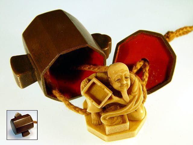 An Edo period "trick netsuke" of Daikoku's hammer. When opened, an ivory netsuke of Japanese folk hero Urashima Taro appears in the hammer.