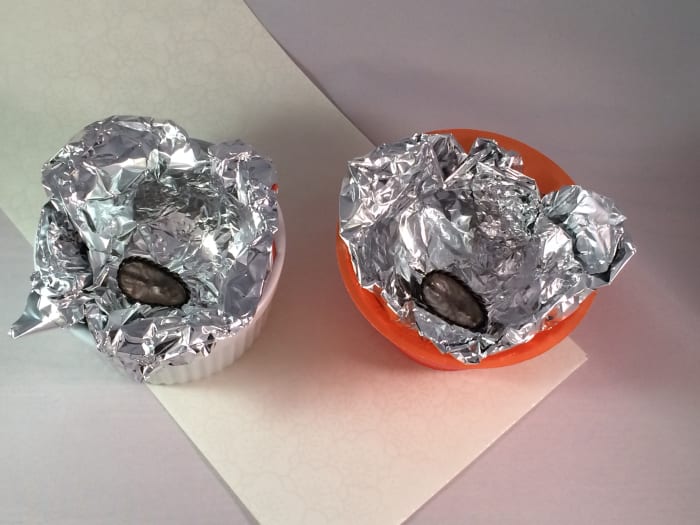 In this experiment both earrings came out equally cleaned. I used porcelain on the left and plastic on the right. Notice, though, that both cups are completely lined with aluminum