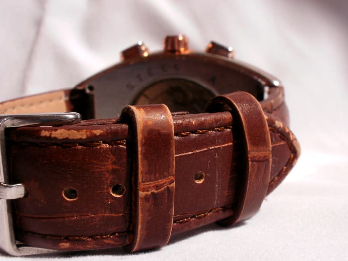 Three weeks of normal wear and tear has taken its toll on the brown colored surface of the watchstrap