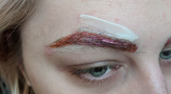 Where I have placed wax here is where you could probably start. As you can see, I've applied close to the pink outline, but not too close, because I don't want to pull up too much. Remember to pull the strip towards your nose when removing wax.