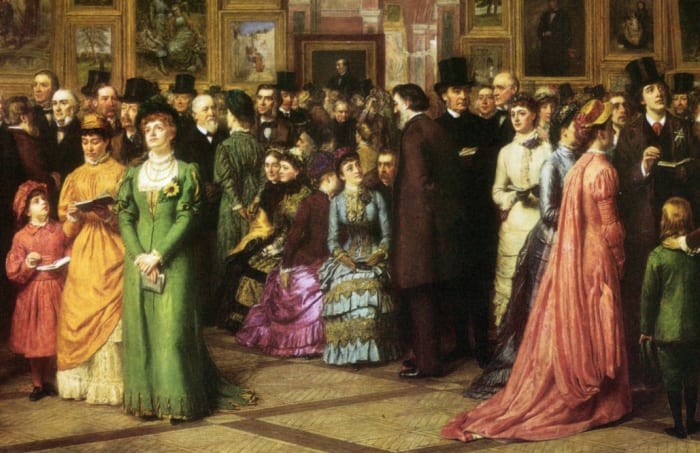 The man in the top hat at the right is Oscar Wilde. The woman in white beside him is Lillie Langtry.