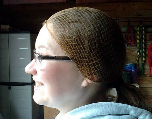 Steps five through seven: Secure the hairnet over your ears and push the knot on your forehead up to your hairline.