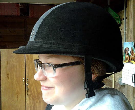 Step ten: Finish adjusting hair so that it remains under the helmet. Piece of cake. Now if only riding were this easy!