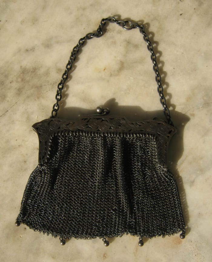 Vintage metal mesh bag with embossed metal frame from the early part of the 20th century