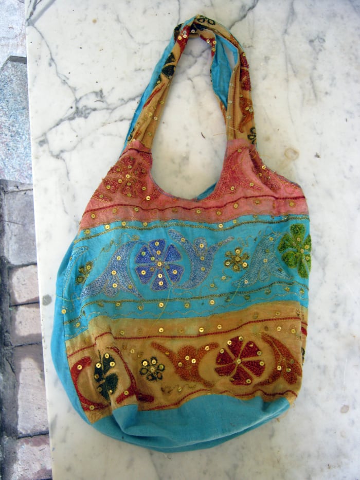 Hippie style bag includes exotic elements, different fabrics, mirrors, and embroidery