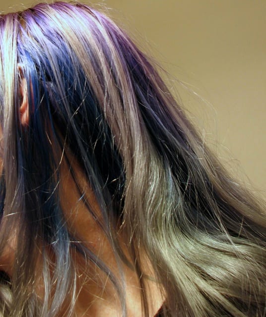 Over two months after dying, it faded in stripes. The hair underneath is still dark blue, because it isn't exposed to the sun.