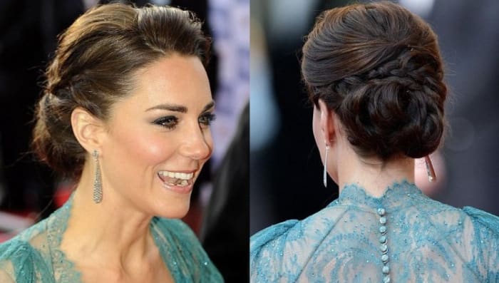 Kate ties her hair in a lovely Chignon styled bun. The sides of her neck are graced by royal looking tear-shaped silver earrings. Scouse brows, mascara, hint of shimmery shadow and nude lip color give her a very natural look.