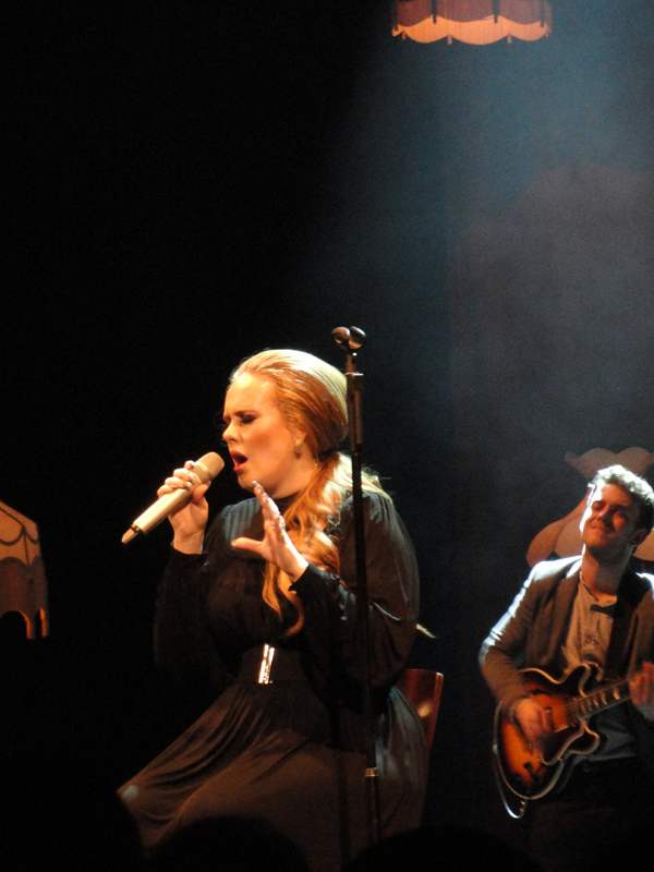 Adele, a plus-size woman, wears flattering dresses.
