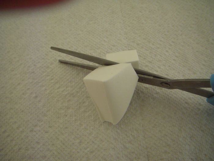 Cut a section of the wedge shaped sponge to make a small piece. The cut side of the small piece should be about as wide as your thumb.