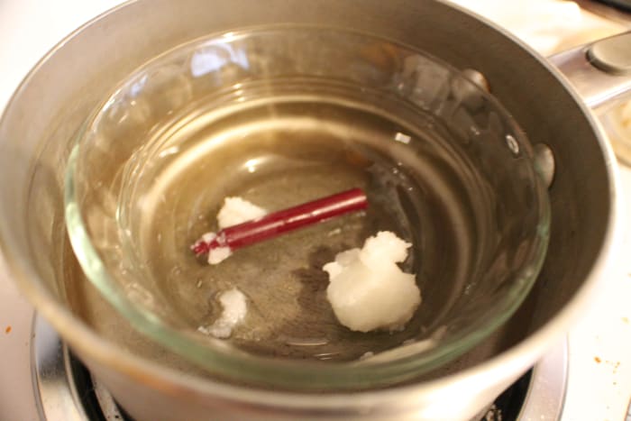 Coconut oil and crayon in the Pyrex bowl placed in the pot of simmering water. You should probably use a bigger pot than I did.