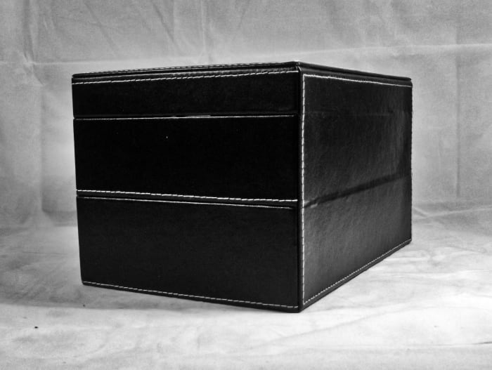 Conventional metal hinges are not employed in the construction of this display case.