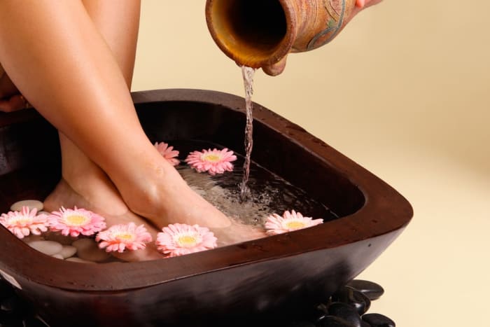 You don't have to have a fancy bowl and flowers like this to soak your feet, a bathtub works just as well.
