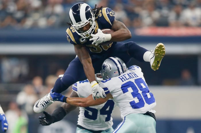Los Angeles Rams running back, Todd Gurley, hurdles over Dallas Cowboys safety, Jeff Heath, during a 2017 game. Gurley is among the greatest running backs in Rams history.
