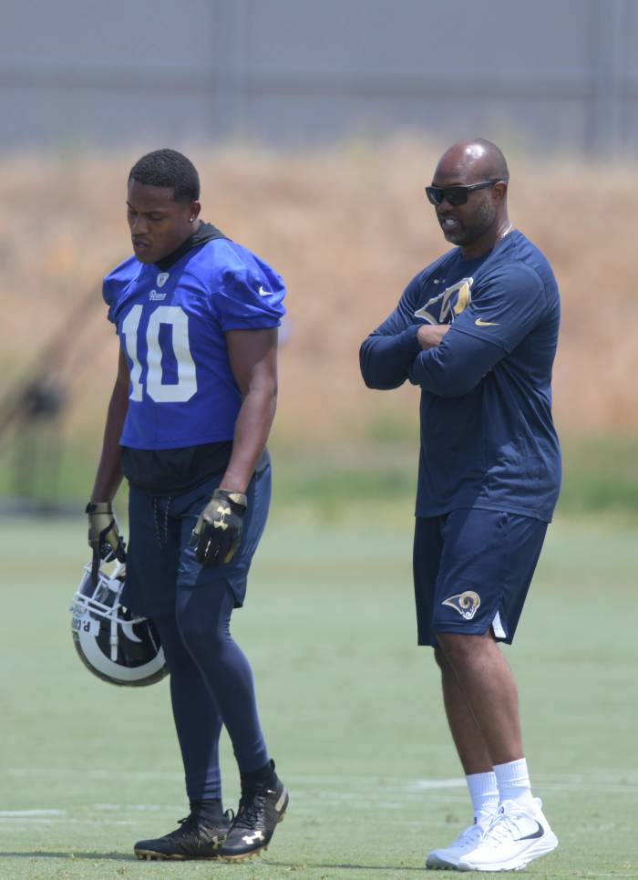 Former St. Louis Rams wide receiver, Torry Holt (right), talks with Los Angeles Rams receiver, Pharoh Cooper, at organized team activities at Cal Lutheran University in June 2018.