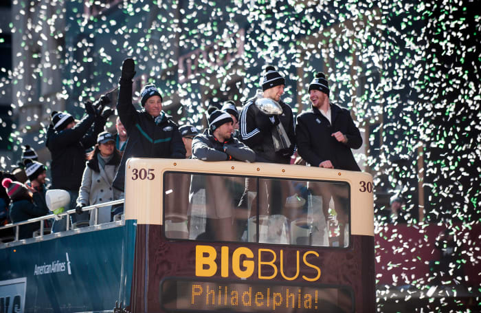 Confetti falls as (from right-left) Eagles QB Carson Wentz, Eagles back-up QB Nate Sudfeld, Super Bowl MVP Nick Foles, and Eagles owner Jeffrey Lurie ride a float during the Philadelphia Eagles Super Bowl LII victory parade, Feb. 8, 2018.