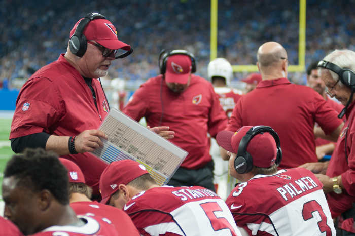 Former Arizona Cardinals head coach, Bruce Arians, talks to quarterback, Carson Palmer (3), during a 2017 game against the Detroit Lions at Ford Field.