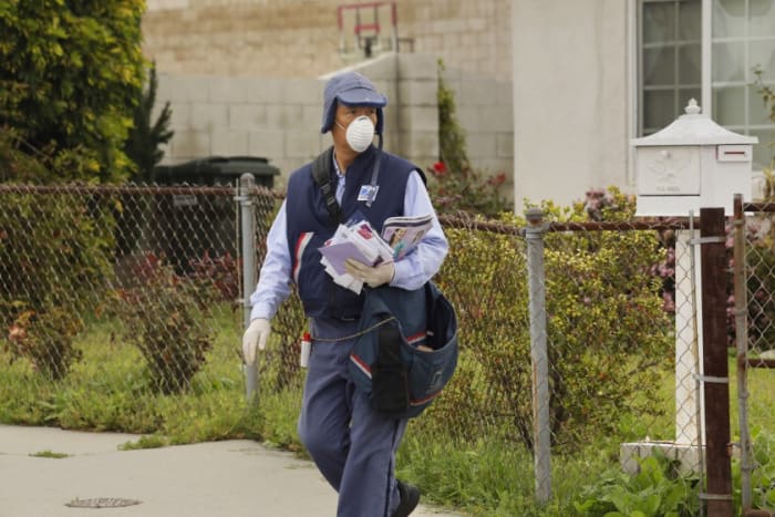 This SoCal letter carrier feverishly goes about his business, dodging dogs, and now, trying to avoid invisible, microscopic biters too.