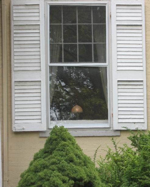 A glowing Candle in the window of the house in Canandaigua, New York that still awaits the return of the son who went off to fight in World War I and never returned.