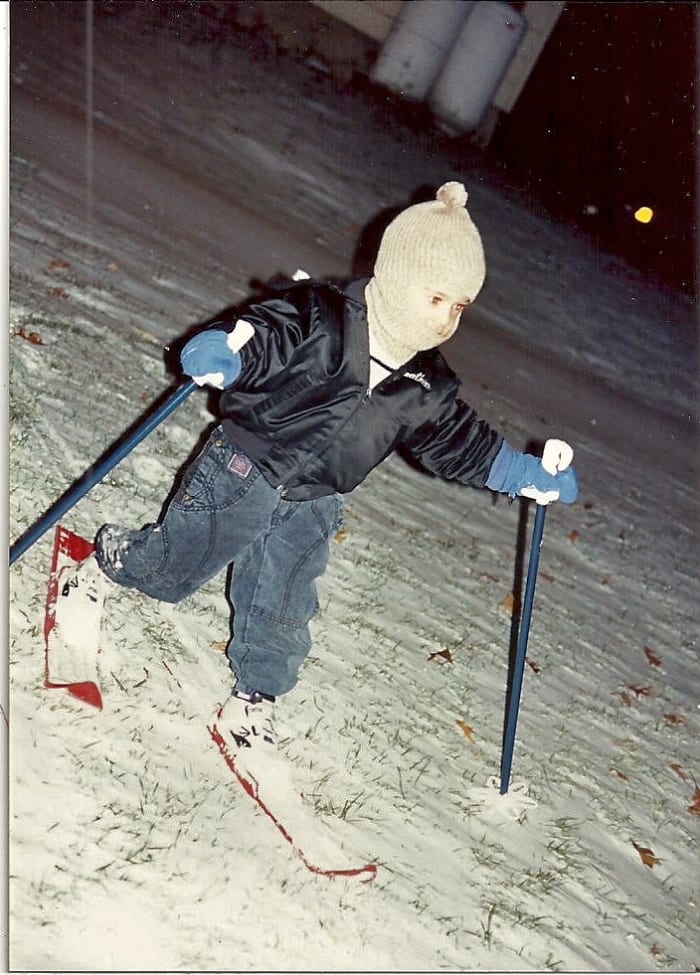 Our grandson on his first pair of skiis as he slid down a small hill behind our house.