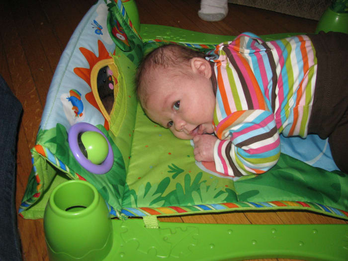 A tummy time mat gives a newborn a comfy and fun area to exercise the neck muscles.