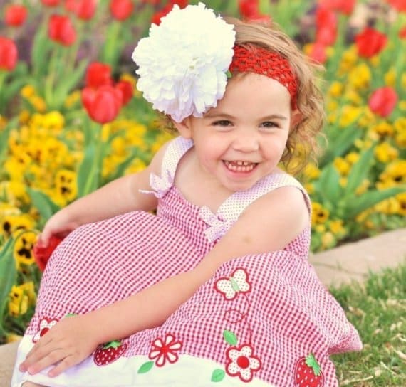 #3 Girl in Red Checked Dress Sitting Among Flowers