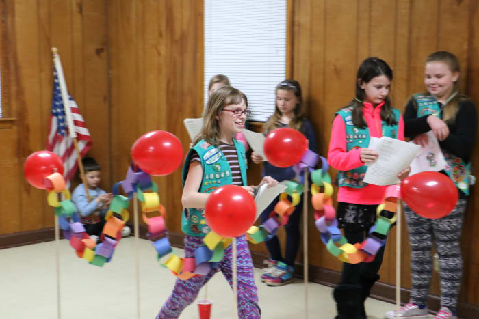 Some awards carry over when girls bridge to the next age level. Here, a troop participates in a bridging ceremony.