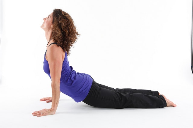 If you are not that flexible in your back, don't lift yourself as far as this; rest on your lower arms instead.