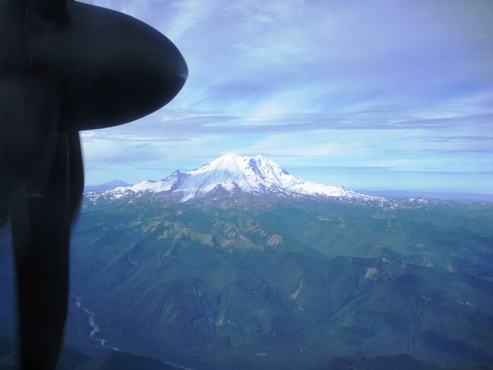 When you look out your plane window and you see a mountain below you, don't panic. Millions of people just like me successfully travel in planes. Would you like a window seat to take great photos? Do you want to see the wing as well, or not?