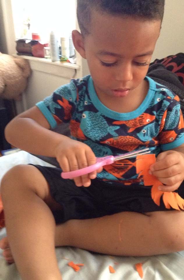 Another option is to let your little one cut up strips of scrap fabric for collage pieces. Snipping at fabric kept Julian entertained for a good 20 minutes. Take care that your child knows how to handle scissors first.