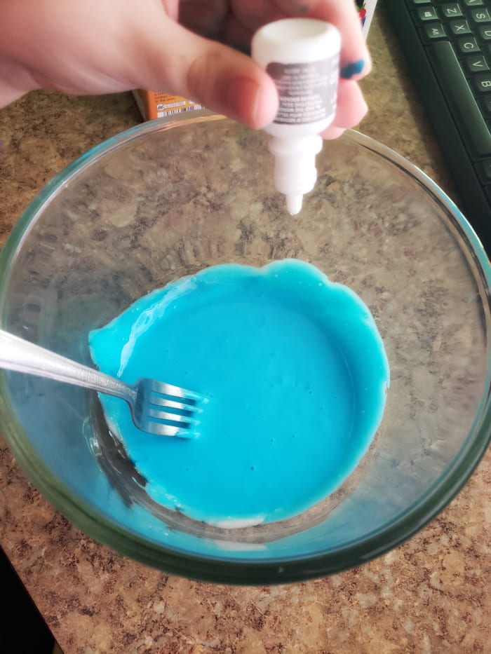 Slowly stir in a few squeezes of the eye drops. Begin kneading the slime, adding in more drops until you get a smooth, Silly Putty consistency.