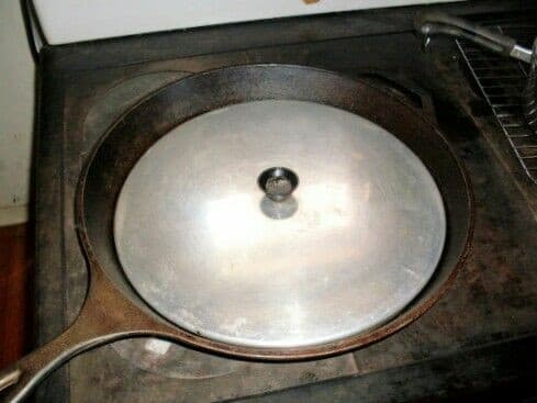 This unusually large cast iron skillet, being 14" in diameter, is big enough to do stir-fry for a medium-size family, or cook several steaks at once.