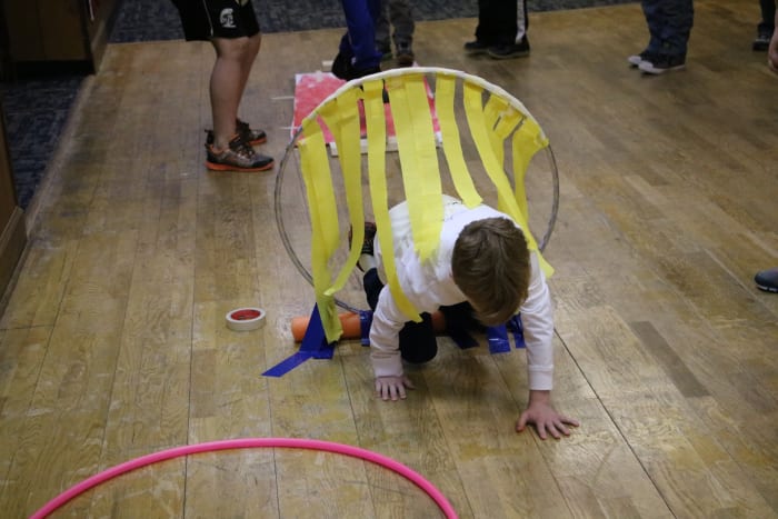 Create a "fiery" ring in your obstacle course using party streamers and a hula hoop. Obstacle courses can be created indoors for parties that occur during winter months!