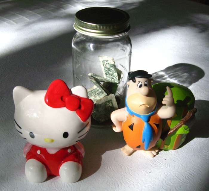Start saving early. A budget can help save enough money for the things we want to buy. - Photo: three different piggy banks.