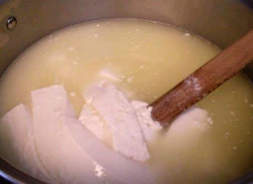 This is what the strips of curds look like once they have been heated a little. They are silken strips, not unlike tofu. The specks are pieces that broke off the strips.