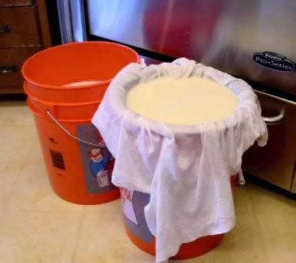 Draining the whey. This is whey from my second pot . . . the first bucket is already full of whey, and ready to be used for other things.