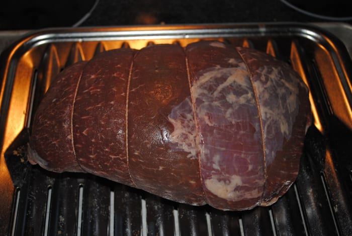 Tying or trussing the roast with butcher's twine helps keep it evenly sized, ensuring even cooking and a more consistent result.