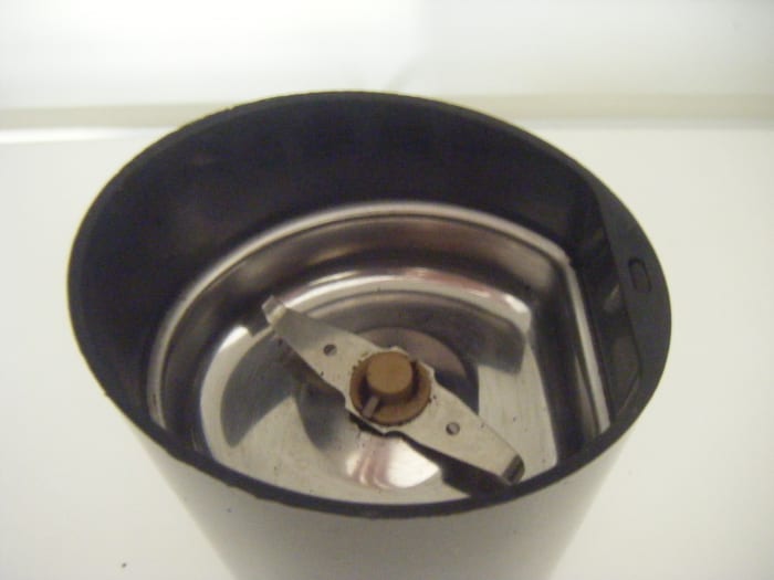 The blades of my Krups F203 viewed from above. The blade spins like a propeller to slice the beans repeatedly reducing them to grounds. The longer the blade spins, the finer the resulting grounds will result.