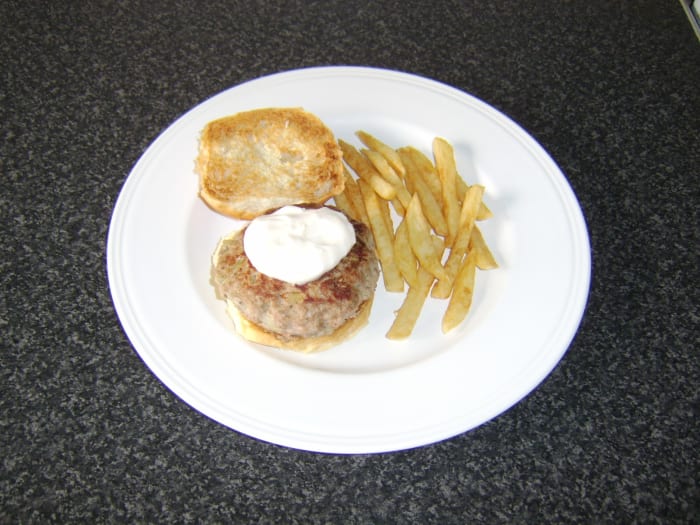 This half pound sage and onion turkey burger is served on a toasted bread roll with garlic mayo and a side of fries