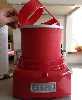Set the frozen freezer bowl on the machine and slip the dasher inside the bowl; note the frost forming on the sides as it hits the warm air?