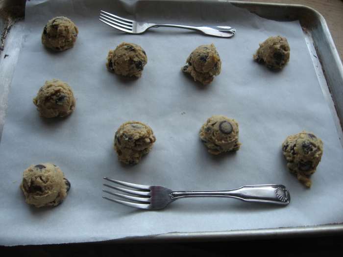 Use a parchment paper on sheetpan and place same size scooped cookie dough leaving spaces in between.