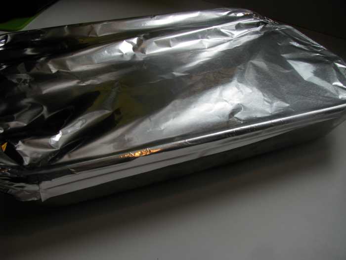 Cover chicken dinner baking dish with foil and bake