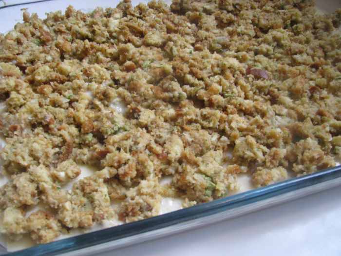 Place prepared stuffing mix on top of Swiss cheese