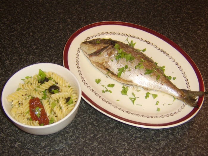 Oven baked whole sea bream served wimply with some fusilli pasta, sun dried tomatoes in olive oil and black olives