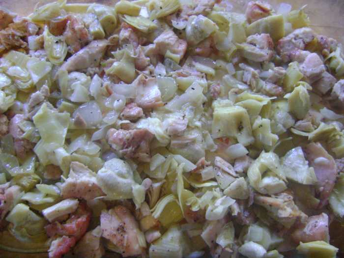 Step 7: Add the chicken, onion and artichoke mixture, then Step 8 - sprinkle cheese and enchilada sauce evenly over the mixture.